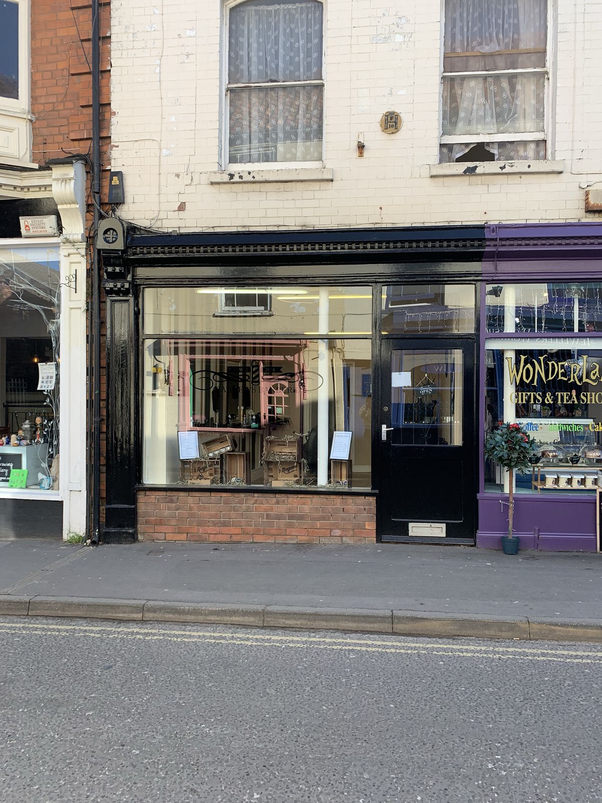 The black shopfront of Harper's Barbers on Queen Street, Louth