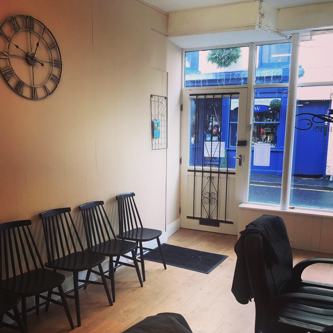 The front door and waiting chairs inside Harper's Barbers
